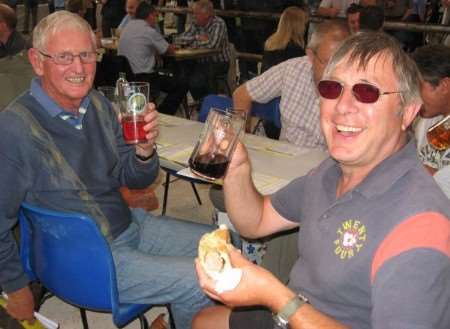 Kent Beer Festival visitors Malcolm Theaker and Bob Giles, from Faversham, try some of the ales on offer. Picture: Matt Hoople