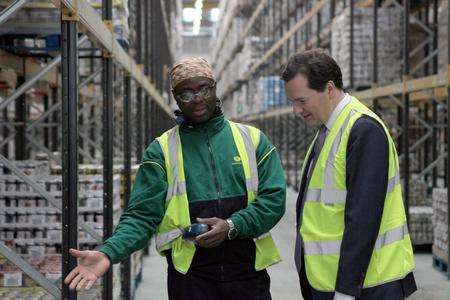 Chancellor George Osborne talks to staff members at Morrisons distribution centre in Kemsley before a keynote speech