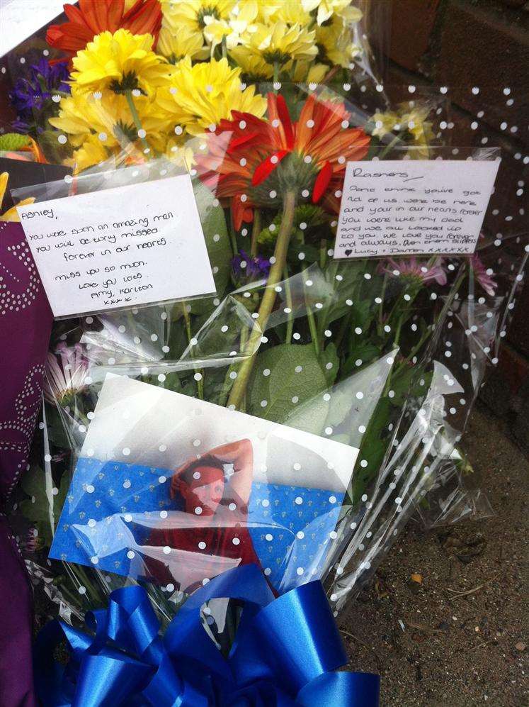 Floral tributes have been left at outside the garage
