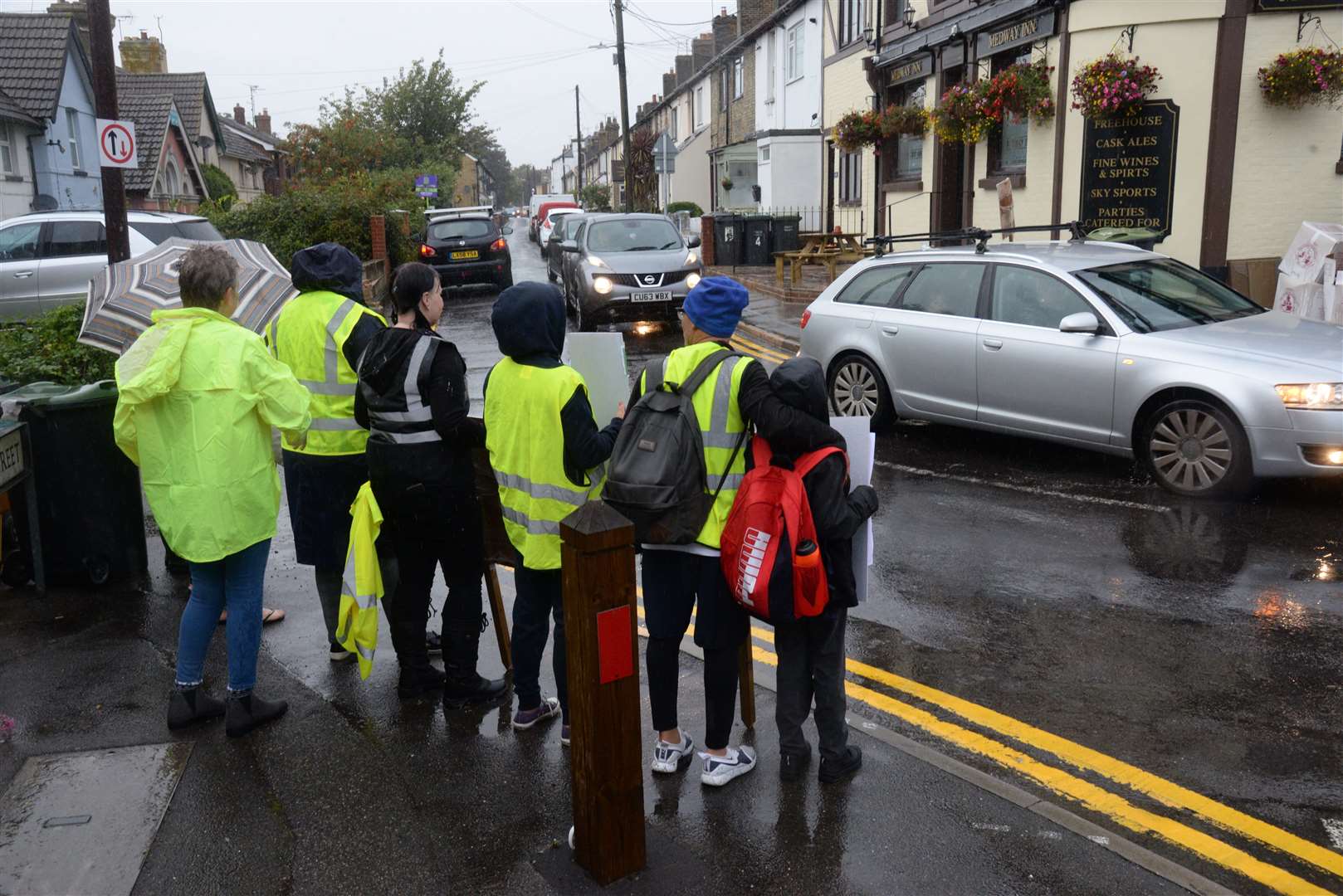 Residents line the street in Wouldham to protest against traffic on Wednesday morning. Picture: Chris Davey. (16109661)