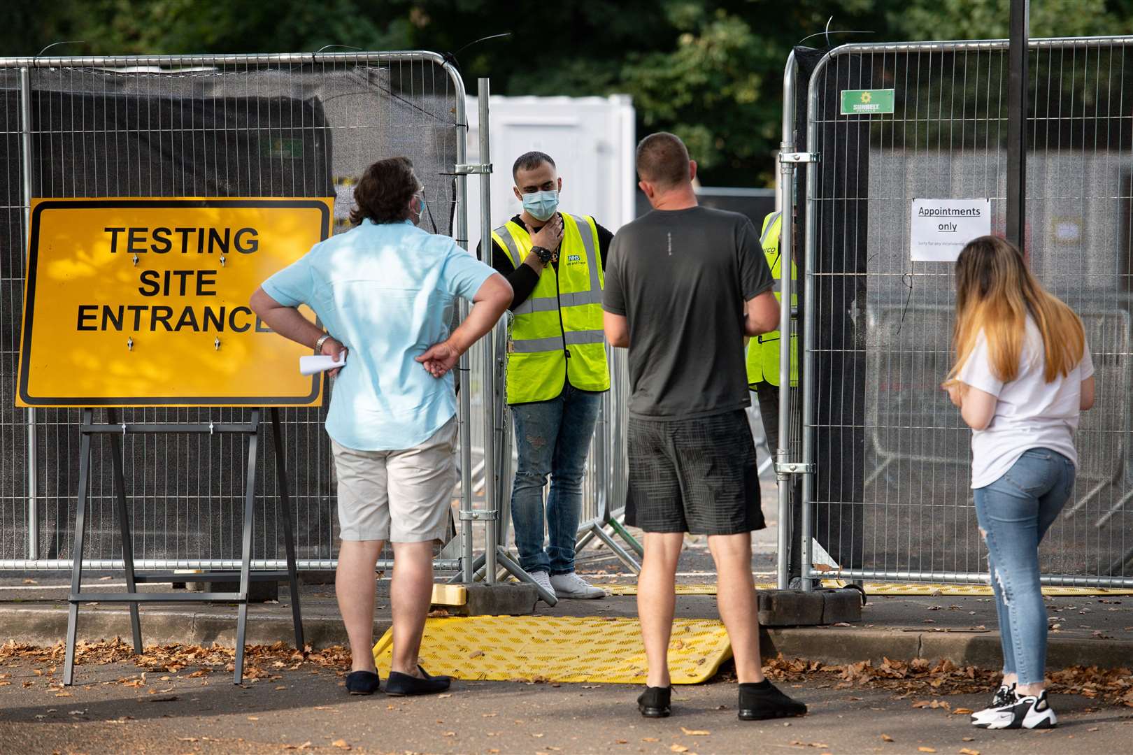 Members of the public speak with staff at a coronavirus testing facility in Sutton Coldfield, Birmingham (Jacob King/PA)