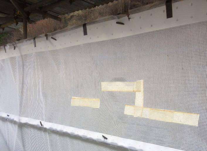 The shelter taped up where cuts were made