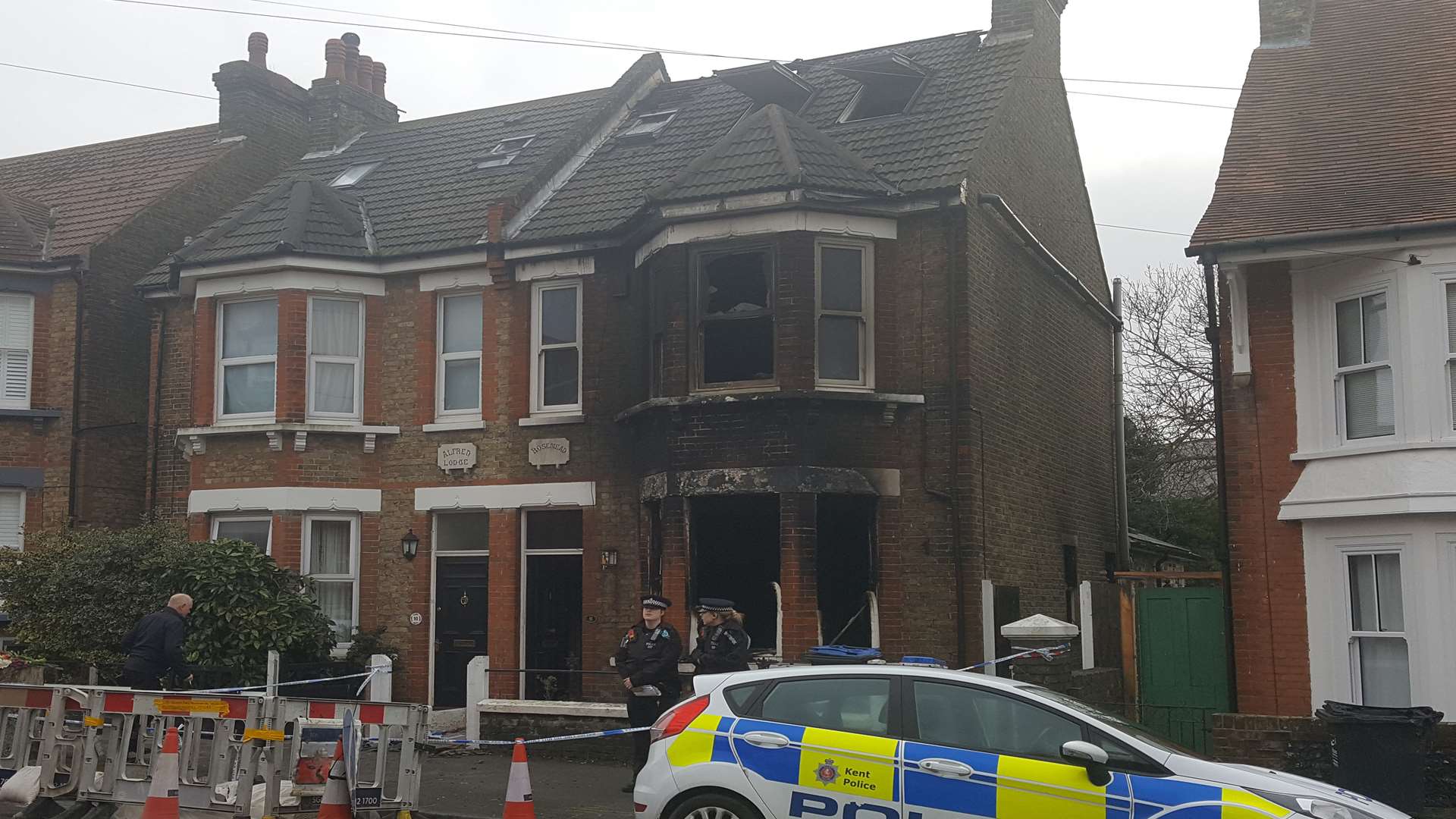 Police remain at the scene of the fire