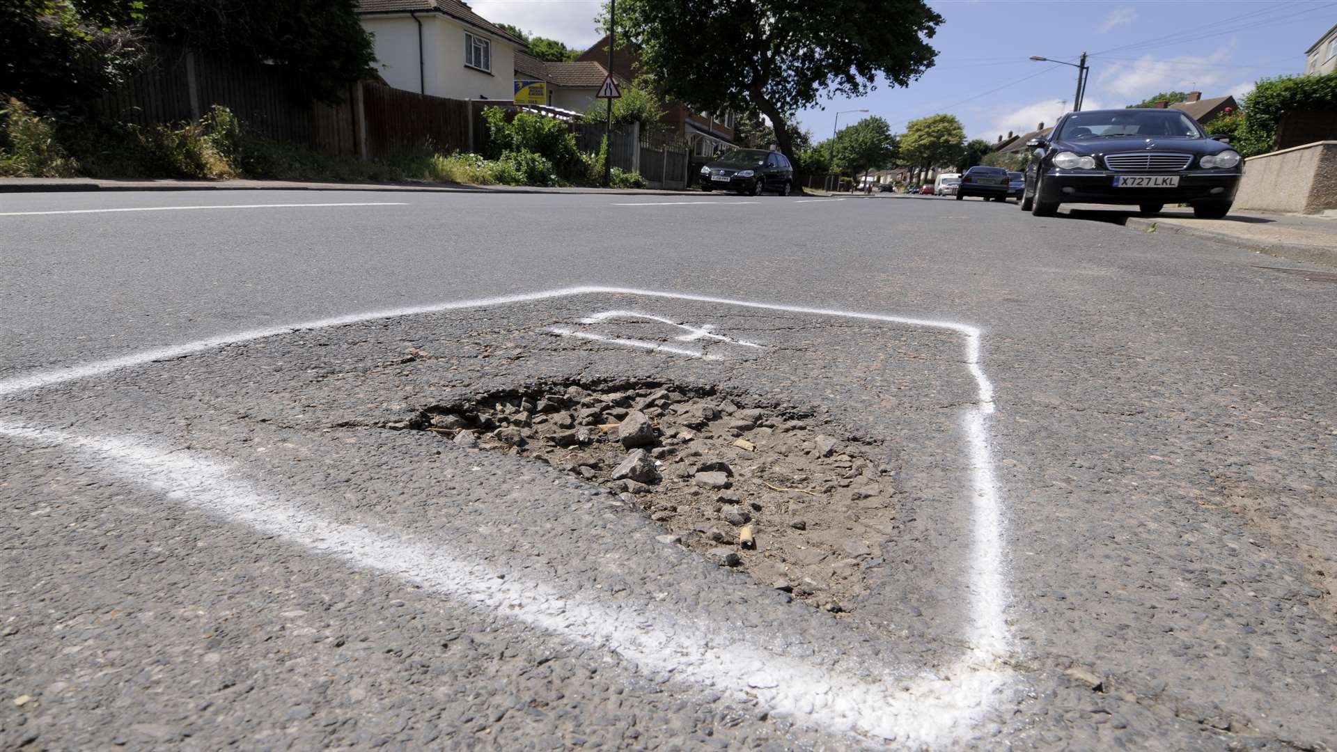 Potholes marked out for repair in Churchill Avenue, Chatham