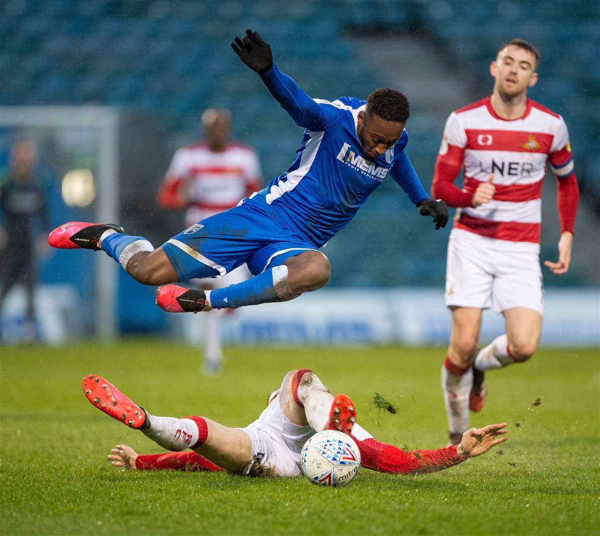 Gillingham forward Brandon Hanlan has to try and hurdle Ben Sheaf's challenge. Picture: Ady Kerry