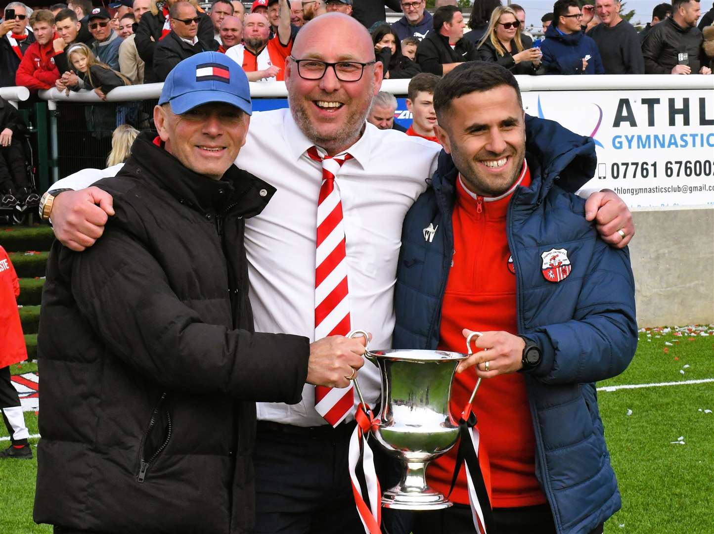 Boss Ernie Batten, joint-chairman Matt Smith and assistant Marcel Nimani celebrate Sheppey's Southern Counties East Premier Division success last season. Picture: Marc Richards