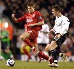 Bryan Hughes puts pressure on Liverpool captain Steven Gerrard. Picture: MATTHEW WALKER