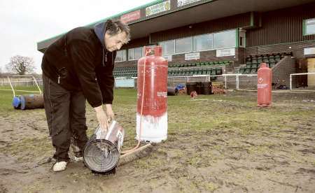 Groundsman Steve Hackett working tirelessly to try and get the pitch playable