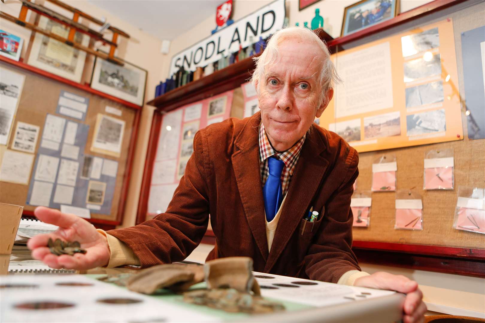 Snodland Museum curator Andrew Ashbee, in 2013, with some of the hoard of Roman coins found in the area. Picture by: Matthew Walker