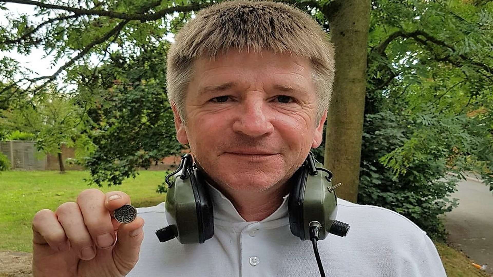 Detectorist Ronnie Carlile with the rare 1,200-year-old coin which could be worth £12,000