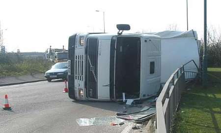 The lorry on its side near the roundabout. Picture: PETER COOK