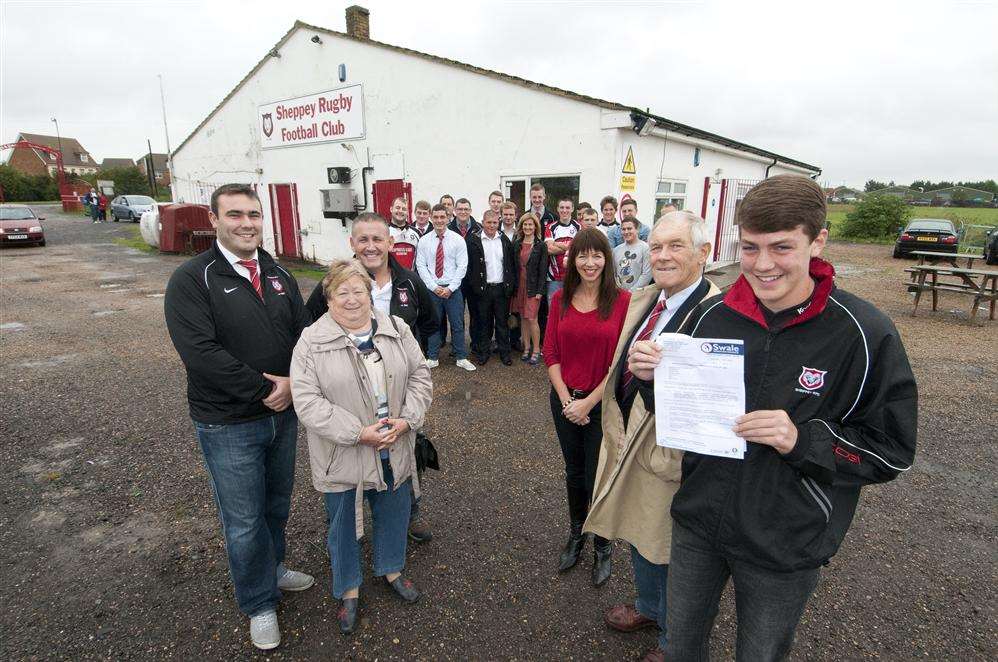Club chairman John Clayton (second from right) and Thomas Golding, son of previous chairman Neil Golding, holding the approval letter for the extension.