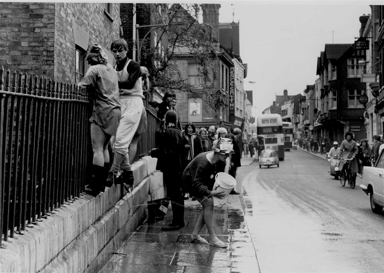 A vain attempt is made to empty the River Stour with buckets at the King's Bridge during 'rag week' in May 1965, when students from Christ Church College, Wye and Nonington Colleges took part in stunts around Canterbury