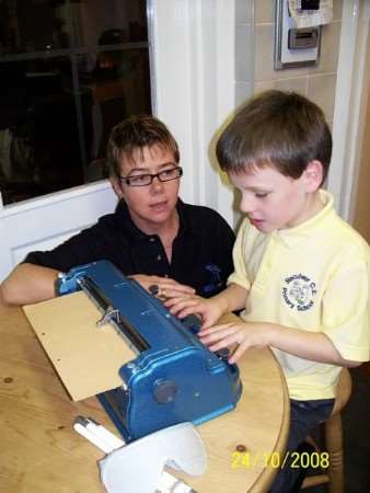 Daniel using his old Perkins Brailler with mum Paula Gunnell