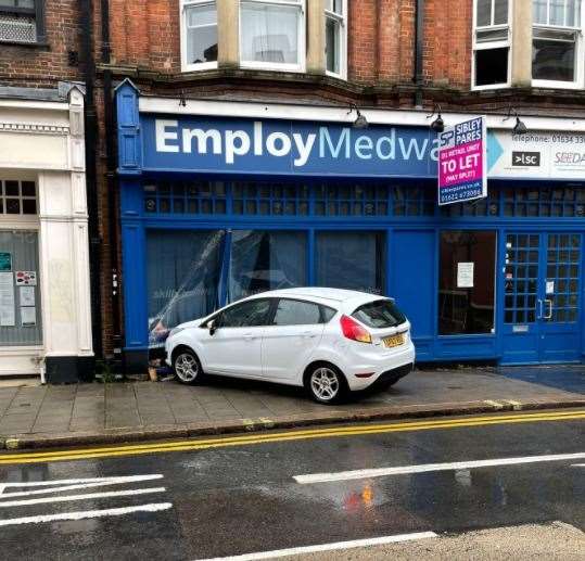 A white Ford Fiesta crashed into the front of the Employ Medway job centre in Chatham High Street. Photo: @tondemazikana