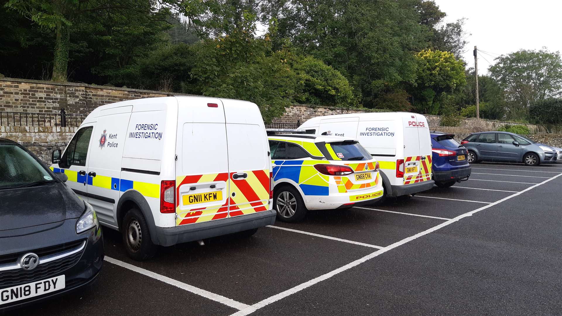 Police vehicles outside Cowgate Cemetery after the body of homeless Piotr Lacheta was found