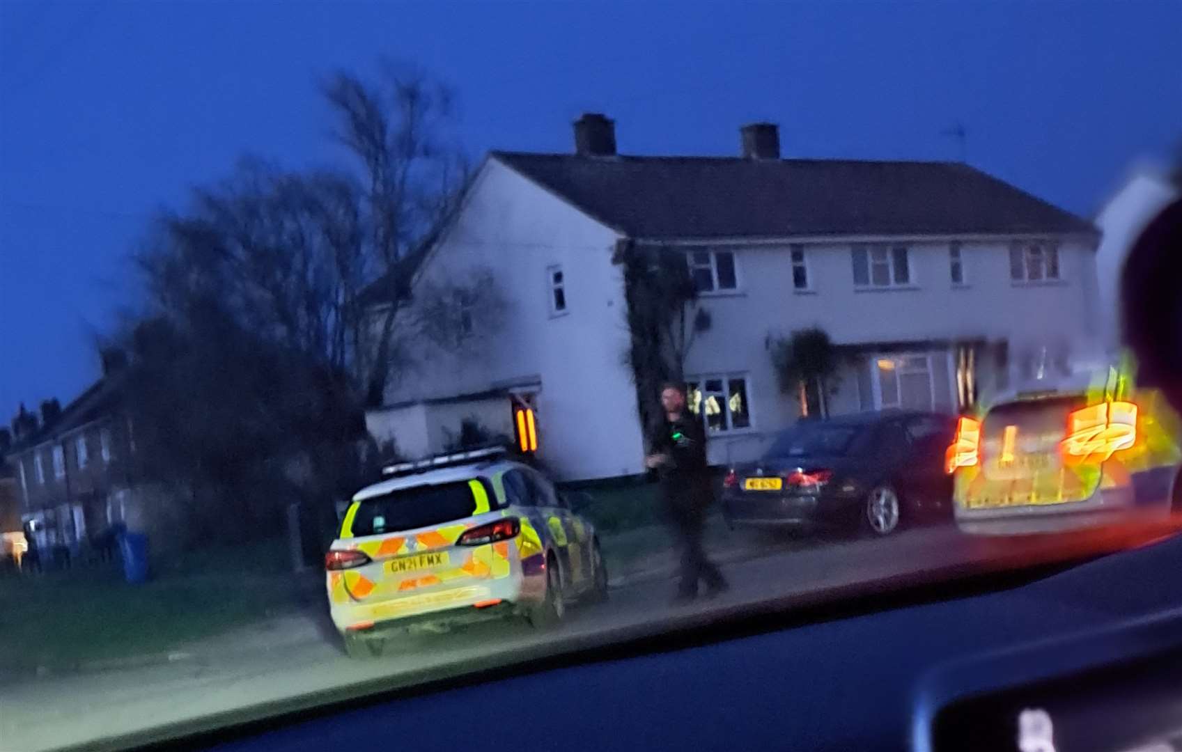 A passerby said It looked like armed officers were going 'in and out of a house'