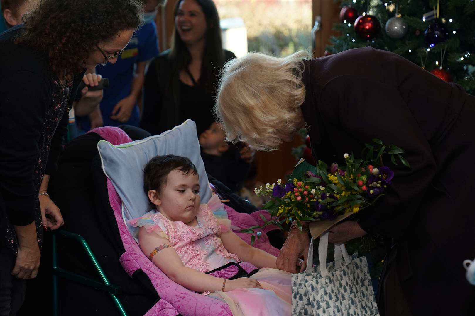 Camilla speaks to seven-year-old Ryleigh Godfrey who presented her with a bouquet (Jacob King/PA)