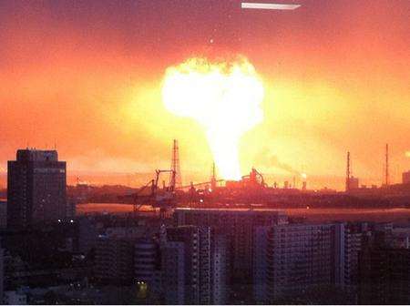 A fireball erupts above the night skyline after an earthquake hits Japan