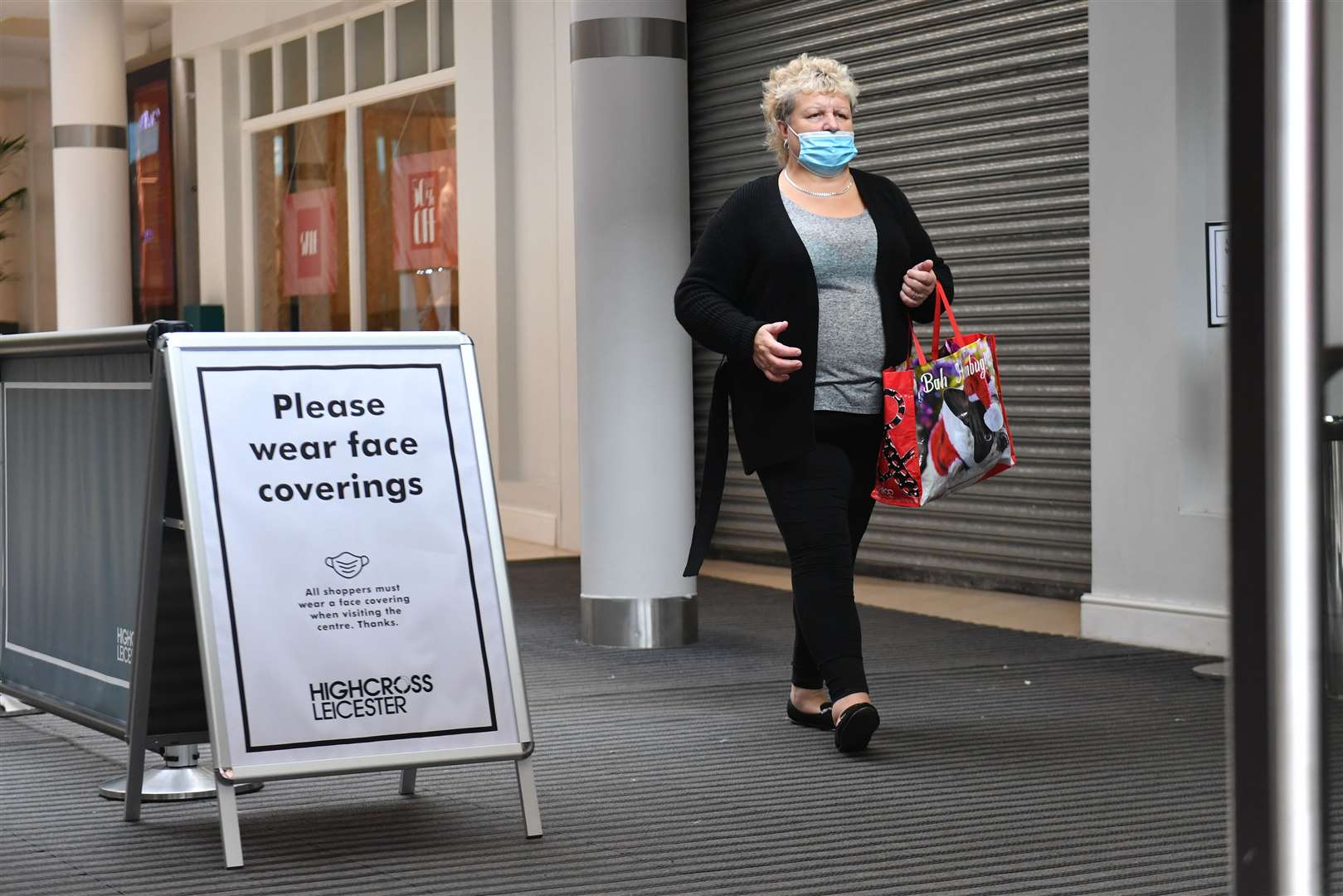 A shopper wearing a face mask leaves the Highcross shopping centre. (Jacob King/PA)