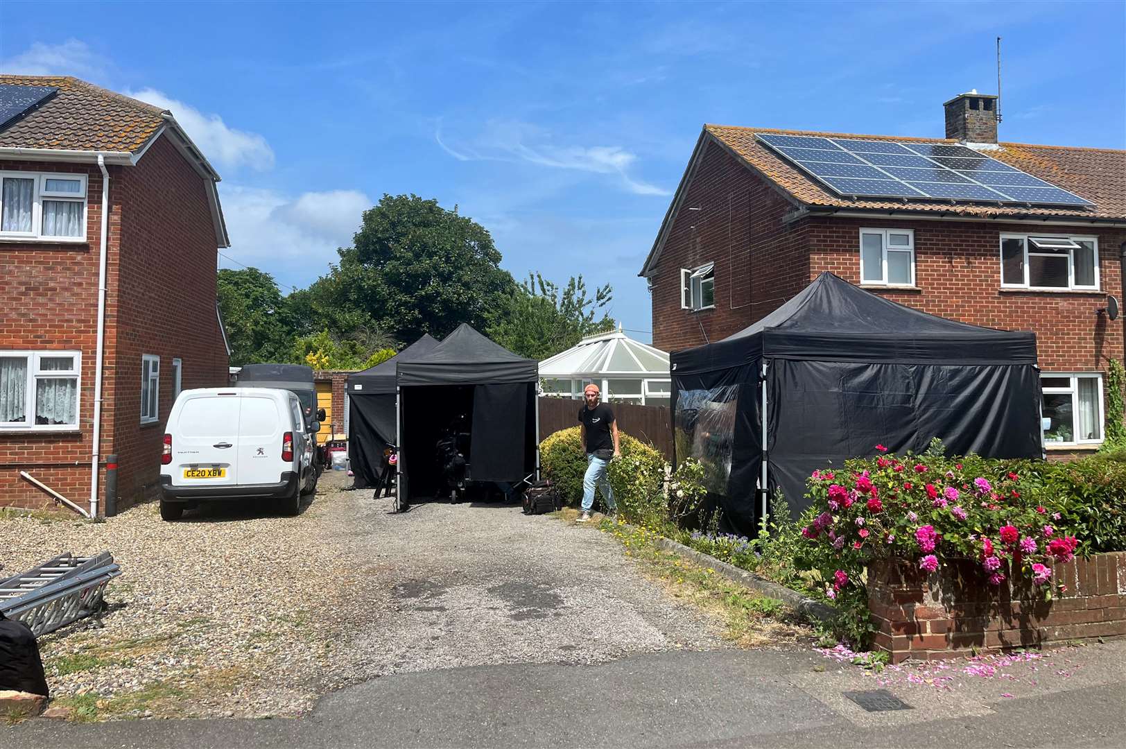 Black tents set up in two front gardens in Church Road in Cheriton, Folkestone, on Monday
