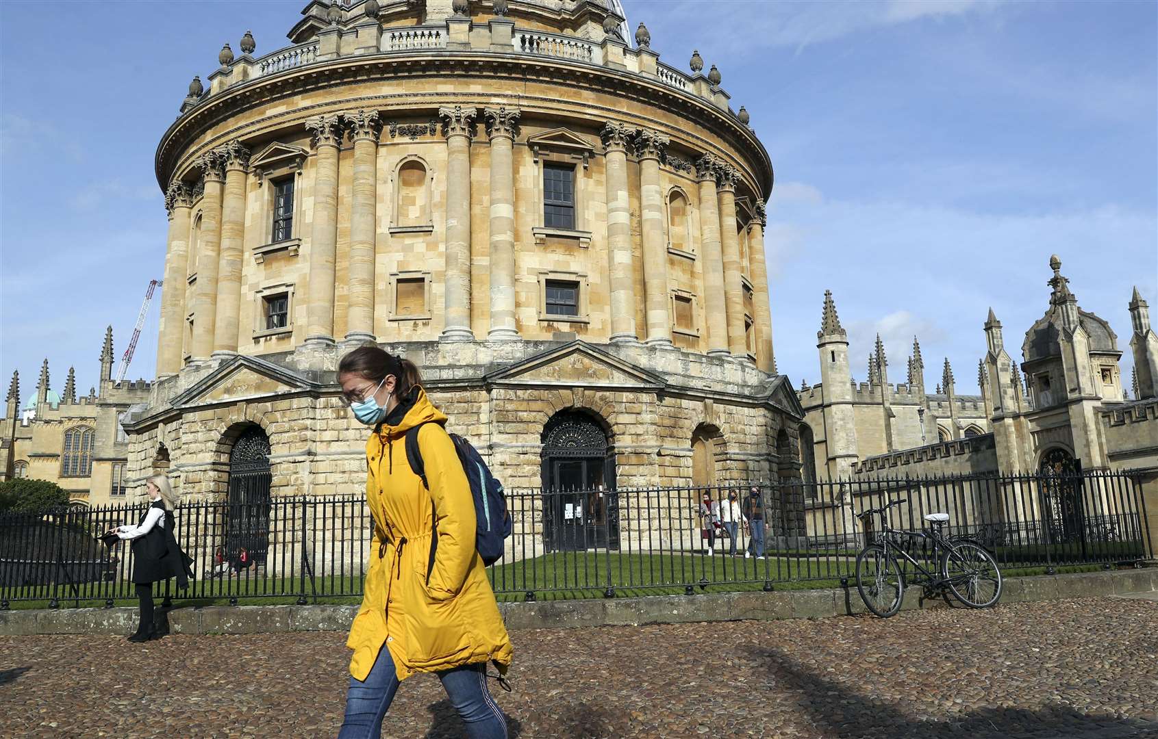 A lady wears a mask as she walks past the Radcliffe Camera library in Oxford (Steve Parsons/PA)
