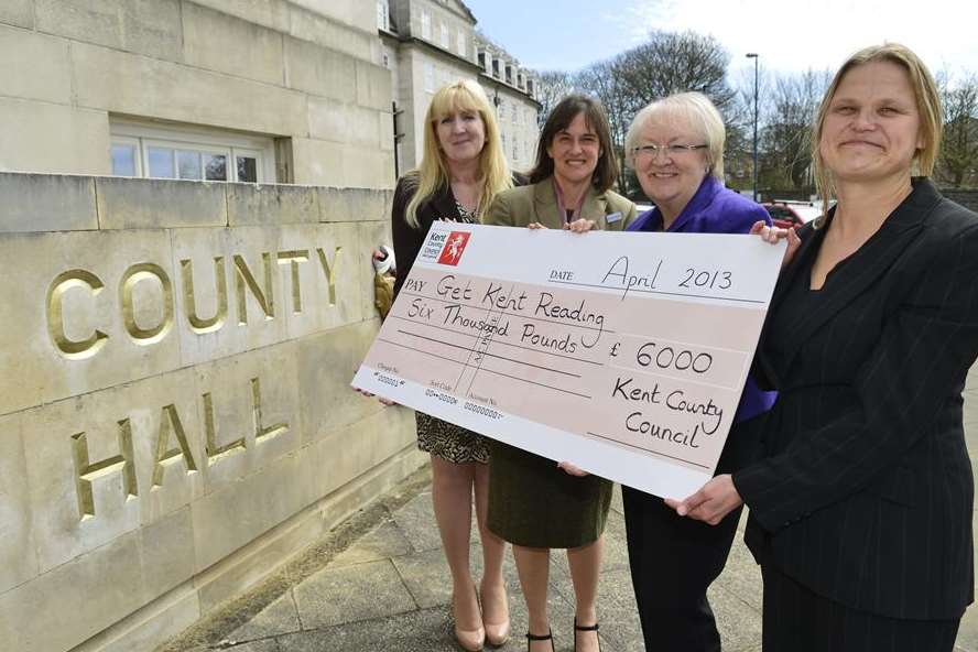 Sue Rogers, KCC’s director of education quality and standards handing over £6,000 to Amelia Shaw, Anne Loftus and Malou Bengtsson-Wheeler, of literacy charity Beanstalk