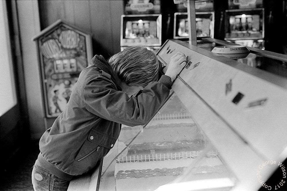 Watching the pennies fall at Cains amusements. Copyright: George Wilson