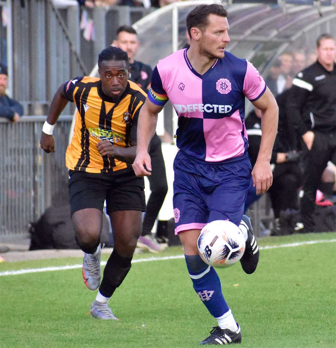 Folkestone's Ira Jackson closes in on a Dulwich Hamlet player. Picture: Randolph File