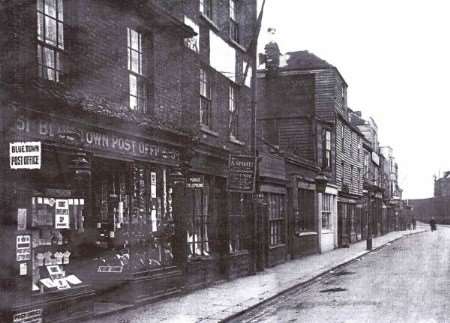 Blue Town High Street: The building in the middle of the picture with the large lantern outside is where the original paper was produced.