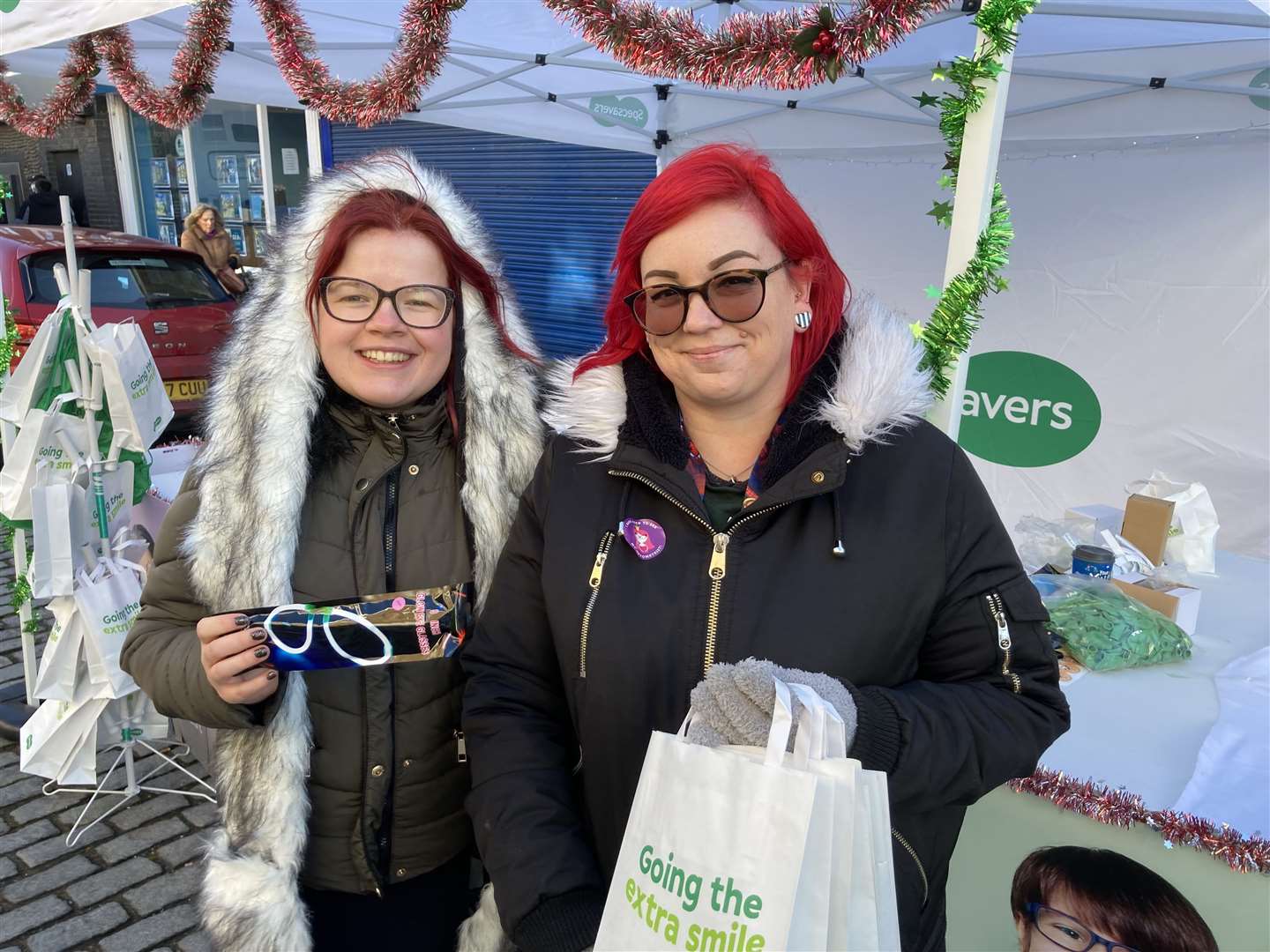 Hannah Kelly, left, and Charlotte Gough from Specsavers' Sheerness store were handing out free glow-in-the-dark glasses to children in the Broadway. The company is sponsoring the Sheerness Town Team which organised the event