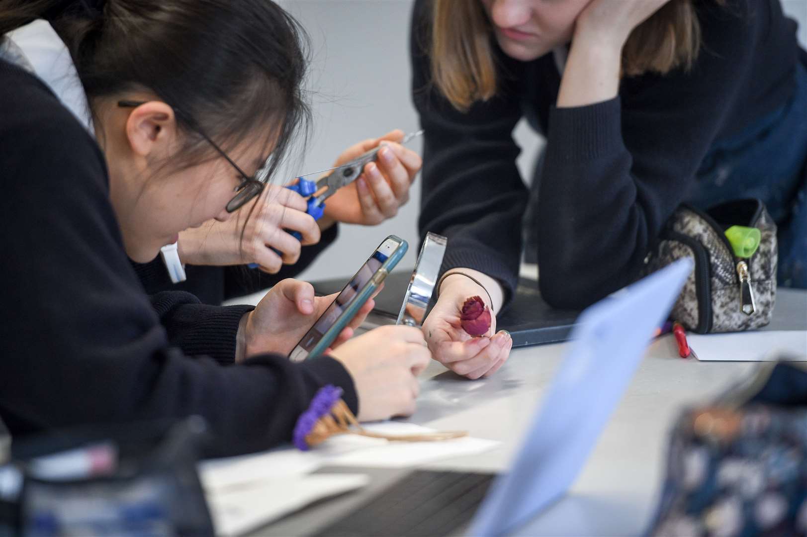 A pupil uses a mobile phone in class (Ben Birchall/PA)