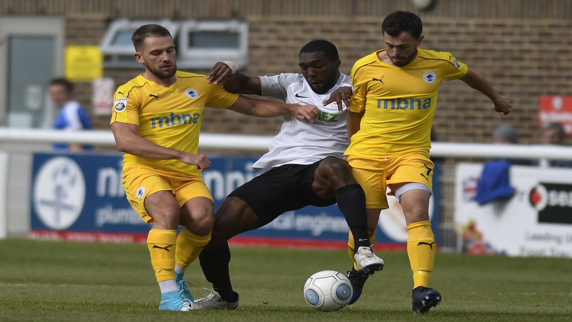 Femi Ilesanmi is flanked by two Chester opponents Picture: Tony Flashman