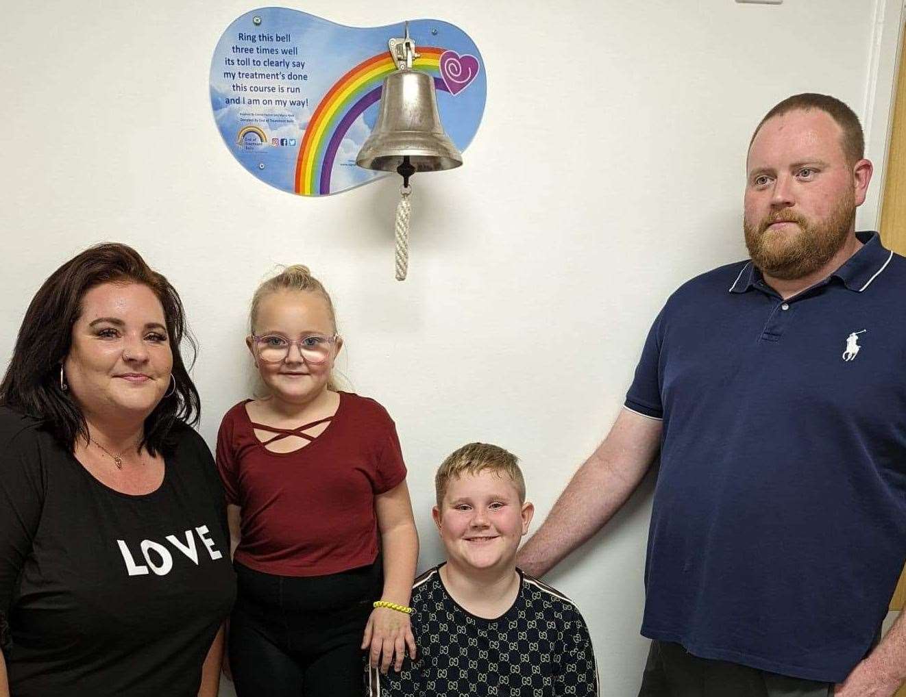 From left, mum Vikki, Ruby, her brother Freddy and dad Rob with the end of treatment bell