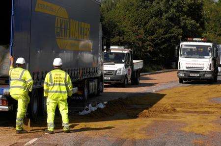 Officals start to clear up a syrup spillage on the A20