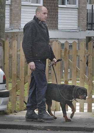 A police dog handler with one of the rottweilers believed to be responsible for the attack