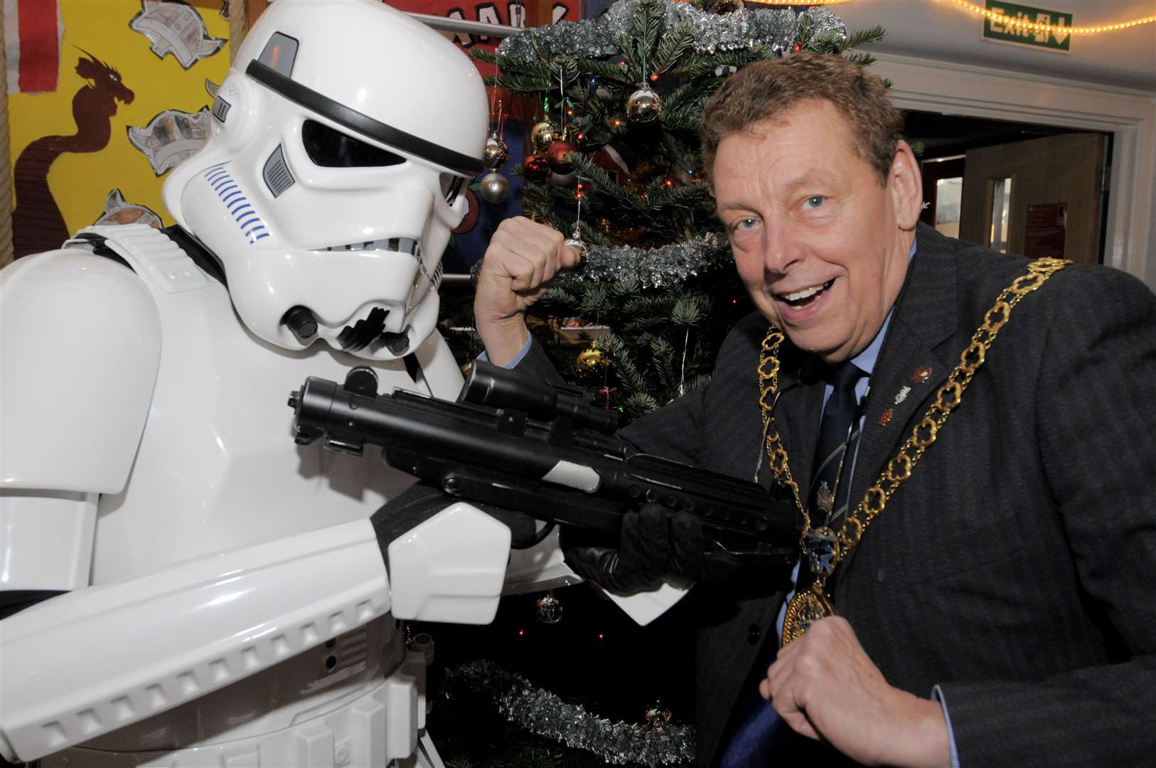 Adrian Crowther takes on an Imperial Stormtrooper at the Canterbury Road Primary School Christmas Fair in Sittingbourne during his mayoral term. Picture: Andy Payton