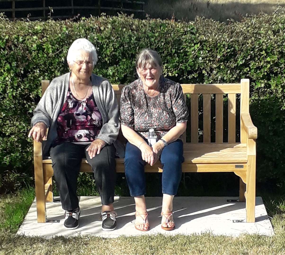 Owen Kinghorn's gran and nan sit on his memorial bench in the graveyard of St Mary's Church