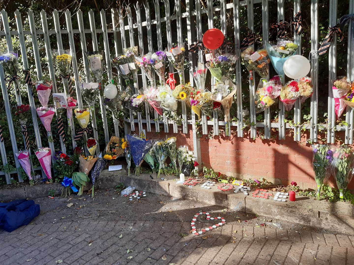 Flowers, candles and written tributes to George Buckley were left at Swanscombe station