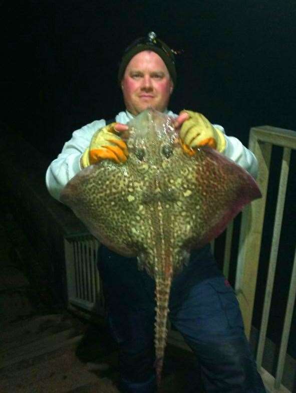 Dale McGurk with the ray he caught from the Admiralty Pier Picture: Richard Allen