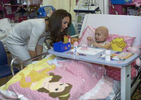The Duchess of Cambridge chats with little Stacey Mowle during a visit to the Royal Marsden Hospital.