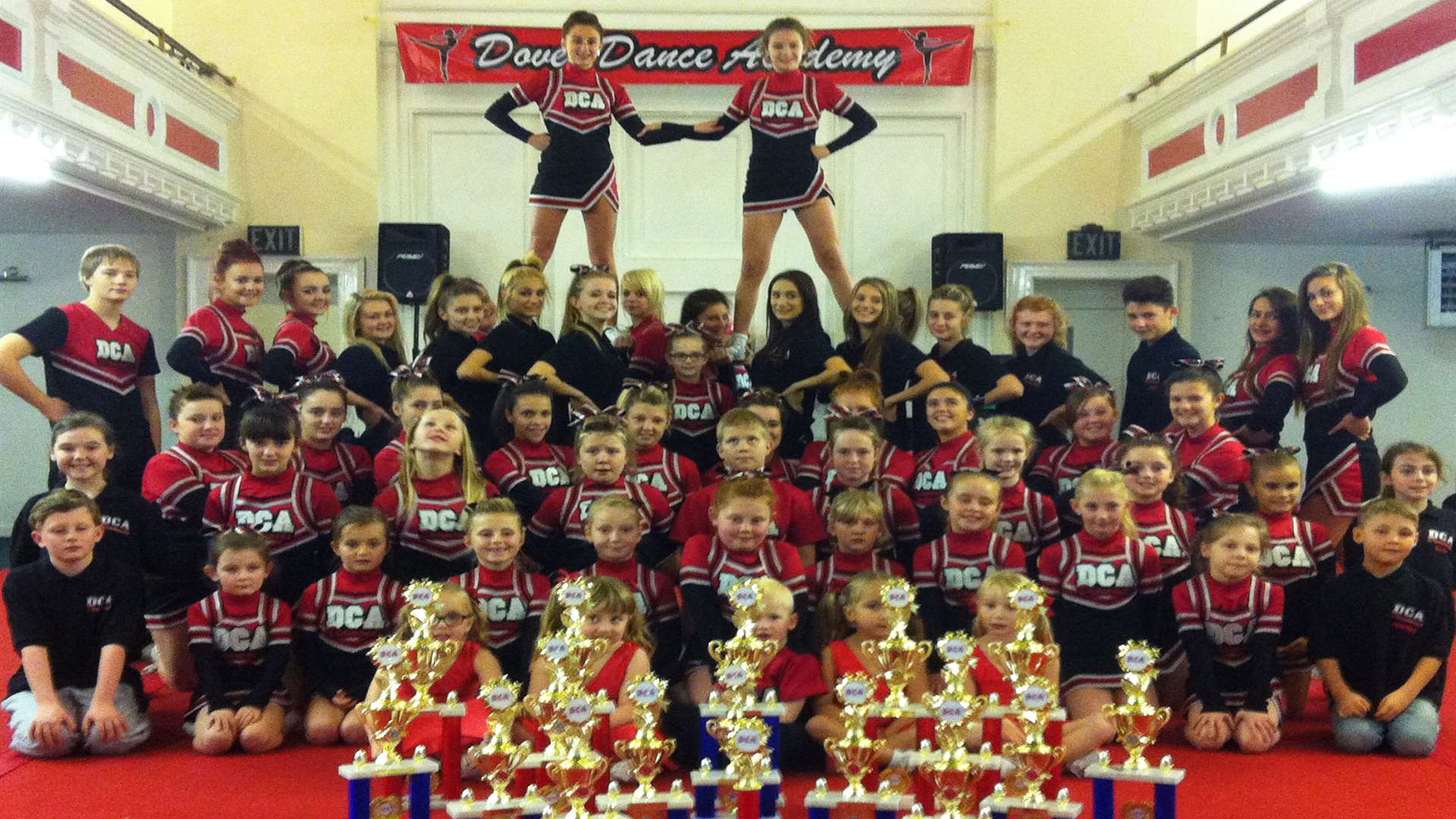Dover Cheerleading Academy with their trophies
