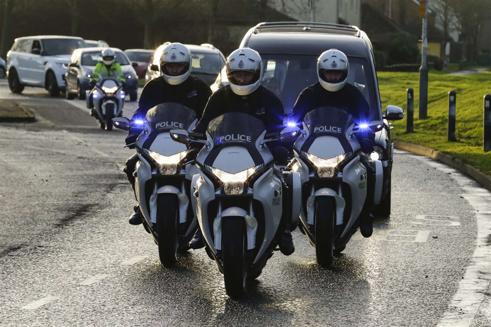 A trio of police motorcyclists give former police bike instructor Michael Copleston an escort at his funeral in Hawkinge