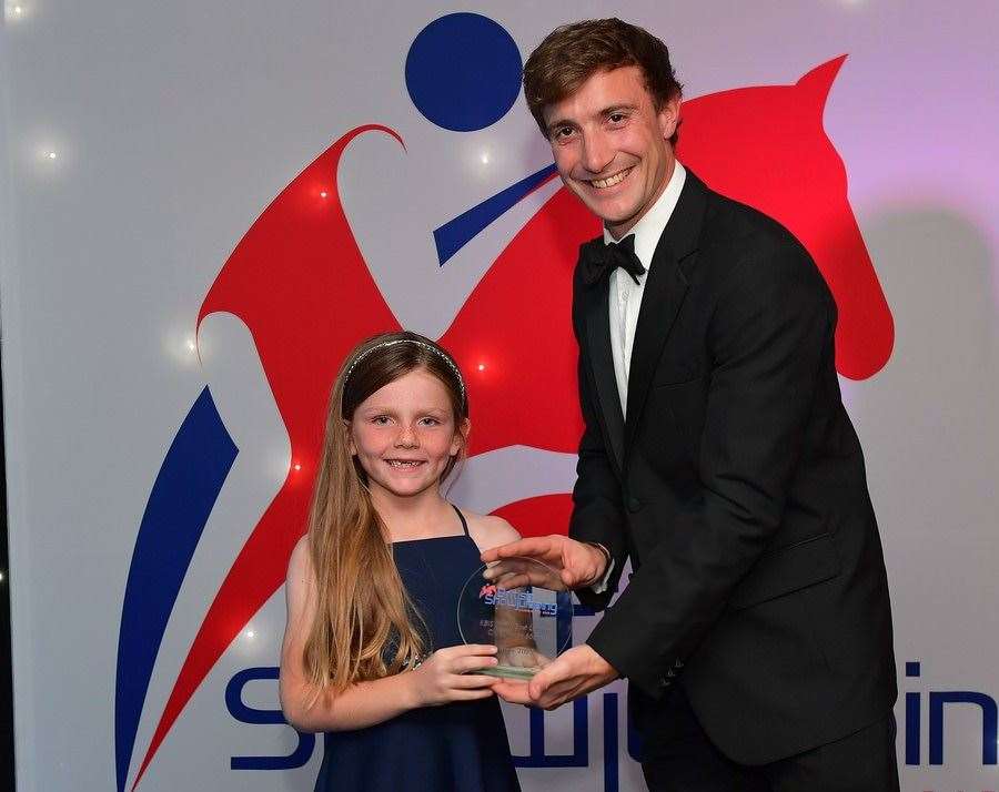 Eliza Cooper, seven, won the KBIS British Equestrian Insurance Club South East Junior 60cm League. Eliza was presented with her award at the British Showjumping Awards Ball by executive director of KBIS, Lawrence Gill. Picture: Simon Coates Photography