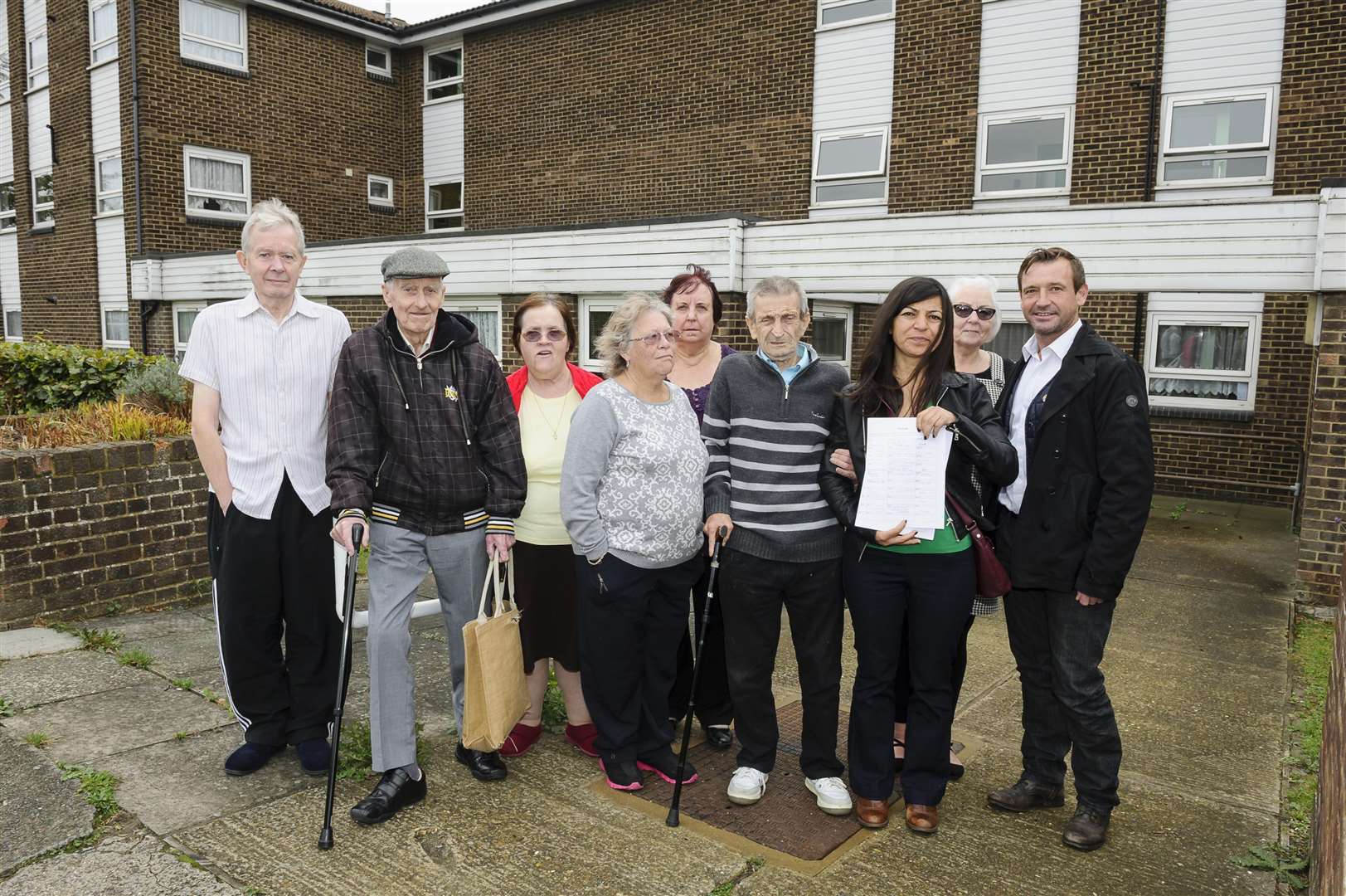Pakize Guvenc holds the petitions with Peter Scollard, right, and residents of Cleveland House