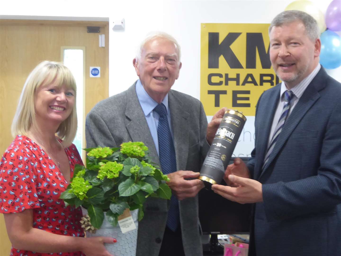 Martin Vye, centre, who is stepping down as chairman of the board of trustees for the KM Charity Team, receives gifts from Karen Brinkman and Simon Dolby in thanks for his years of service. (2747587)