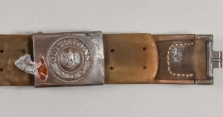 A WWII German belt and buckle, bearing a metal buckle marked 'Gott Mit Uns' over an eagle with swastika.