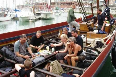 Viking ship crew take a break from rowing
