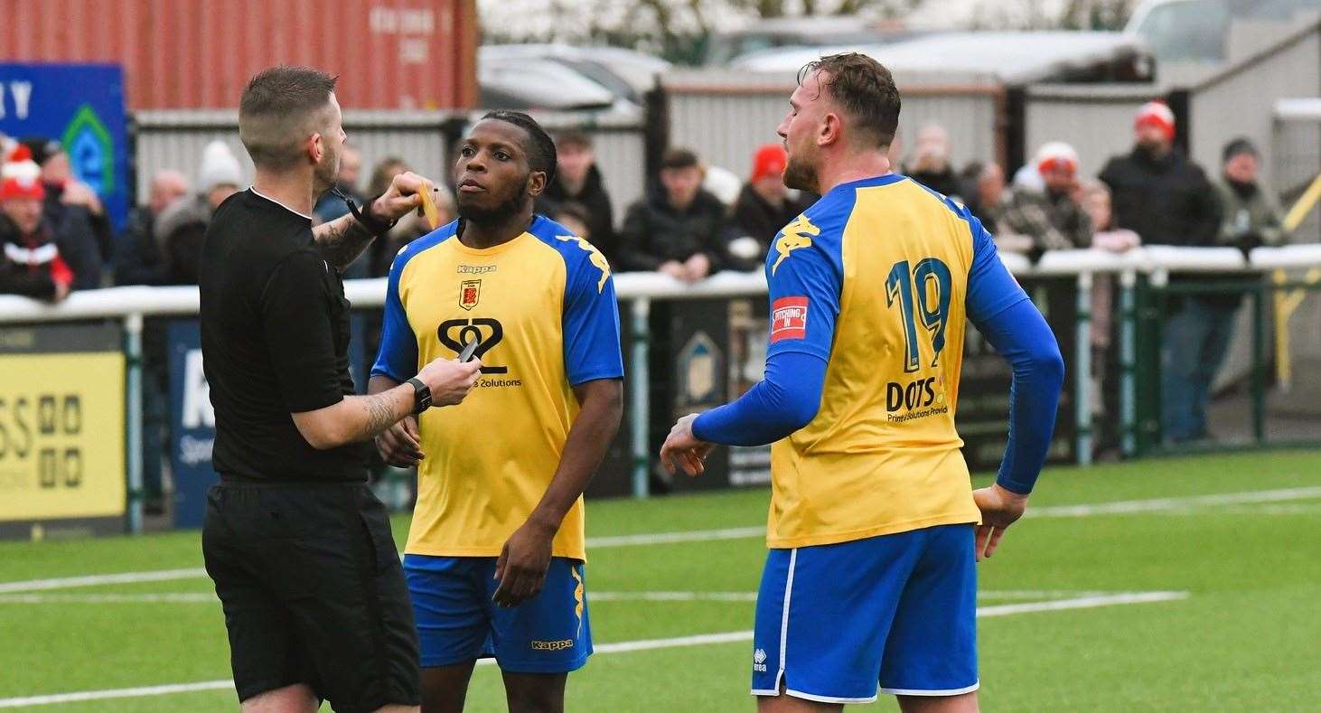 Faversham players Bode Anidugbe and Darren Phillips argue with referee Billy Woods about the award of Sheppey's penalty in the 2-2 draw between the teams. Picture: Marc Richards