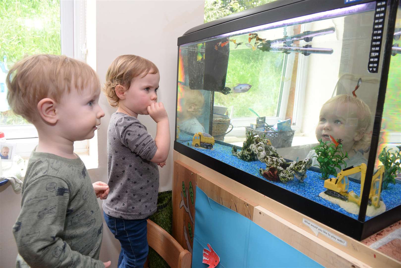 Ellie, two and Jack, one inspect the new fish in their tank at Scallywags nursery in London Road, Rainham